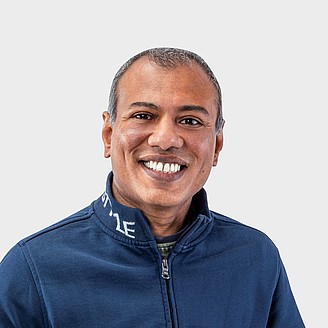 Monirul Hoque, Geschäftsführer von HRM Textil – © HRM Textil / Sonstige/Kommerziell Monirul Hoque hält eine selbst produzierte Mund-Nasen-Maske in den Händen